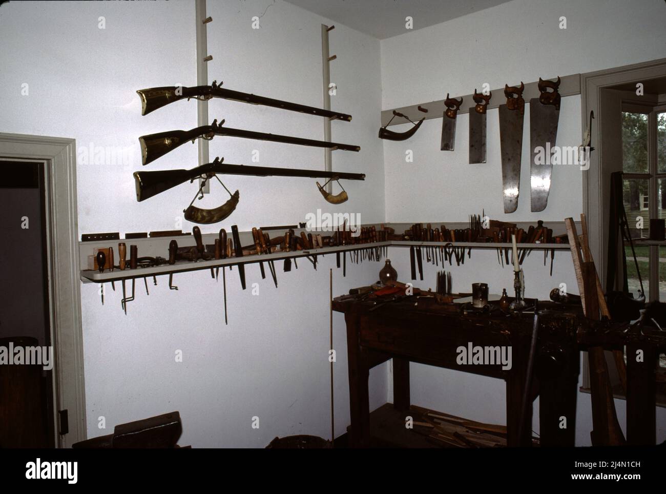 Williamsburg, VA. USA 9/1987. Meisterbüchsenmeister für Colonial 18. Century Gewehre, Pistolen und Fowling Schrotflinten. Mit 18. Jahrhundert Schießwerkzeuge Handwerk jede Schusswaffe von Holzbestand zu sperren. Stockfoto