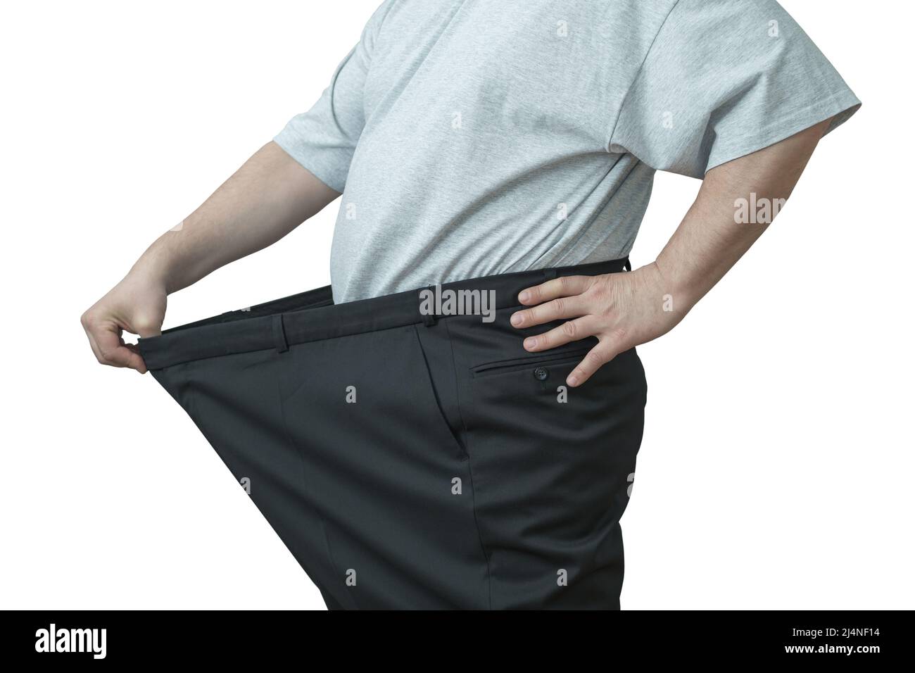 Der Mann zieht an seiner großen Hose an der Taille. Zeigt, wie er an Gewicht verloren hat. Stockfoto