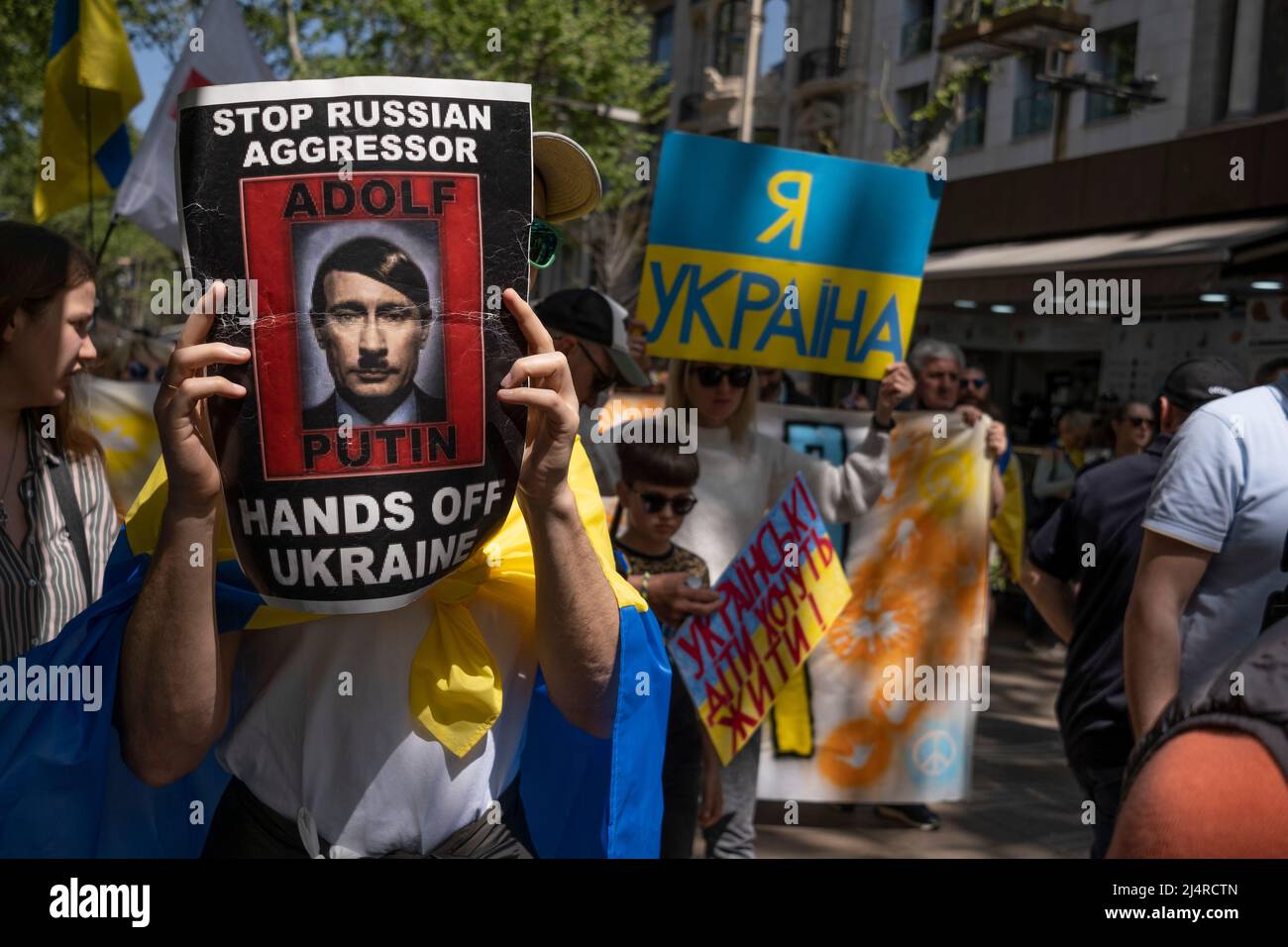 Barcelona, Spanien. 17. April 2022. Ein Protestler zeigt ein Plakat mit einem Bild des russischen Präsidenten Wladimir Putin, das während der Demonstration als Hitler karikiert wurde. Hunderte von Ukrainern mit Wohnsitz in Barcelona haben im Zentrum von Barcelona demonstriert, um ihre Unterstützung für den Widerstand der ukrainischen Bevölkerung zu zeigen. (Foto von Paco Freire/SOPA Images/Sipa USA) Quelle: SIPA USA/Alamy Live News Stockfoto