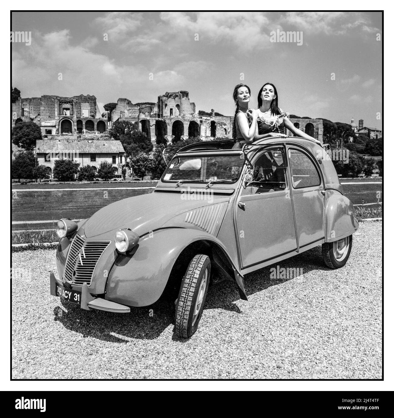 1948 DIE MARKTEINFÜHRUNG VON WW2 2CV IN DER ZEIT nach dem Krieg von 2CV BEI EINEM Werbefoto im Freien mit weiblichen Modellen, die aus dem Sonnendach des legendären, von Flaminio Bertoni entworfenen, von der Firma Croen Deaux Chevaux posiert wurden Stockfoto