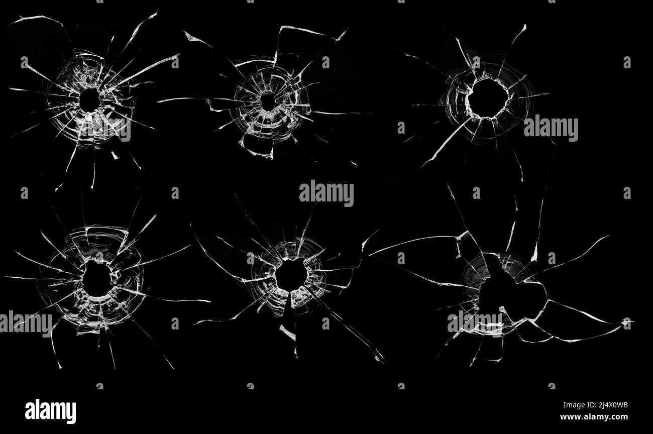 Löcher von Kugeln in Glas auf schwarzem Hintergrund, Sammlung. Stockfoto