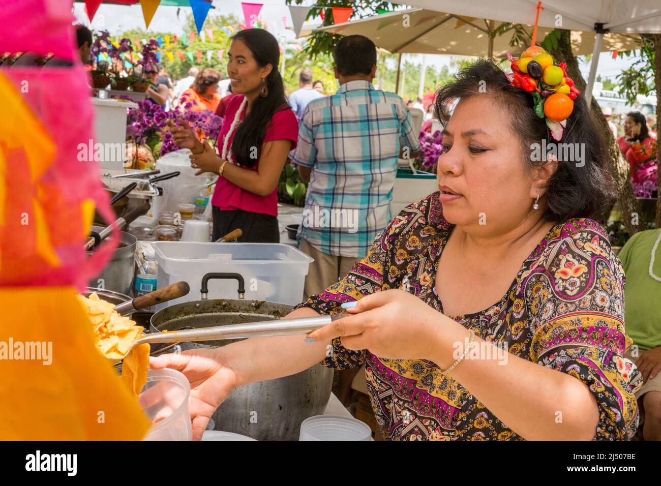 Eine Frau, die beim thailändischen Neujahrsfest im Wat Budharangsi in der Redland-Gegend von Miami-Dade County, Florida, Essen verkauft. Stockfoto