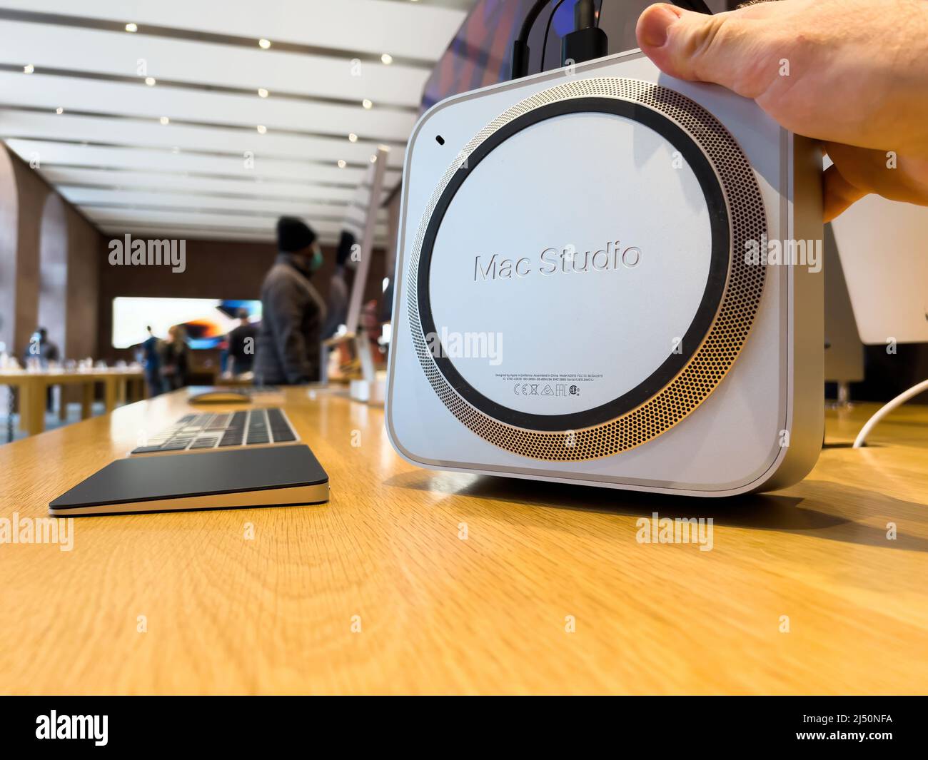 Paris, Frankreich - AP 7, 2022: POV männlich Hand hoilding neuen Mac Studio Macintosh - eine kleine Formfaktor-Workstation entwickelt, hergestellt und verkauft von Apple Inc. Stockfoto