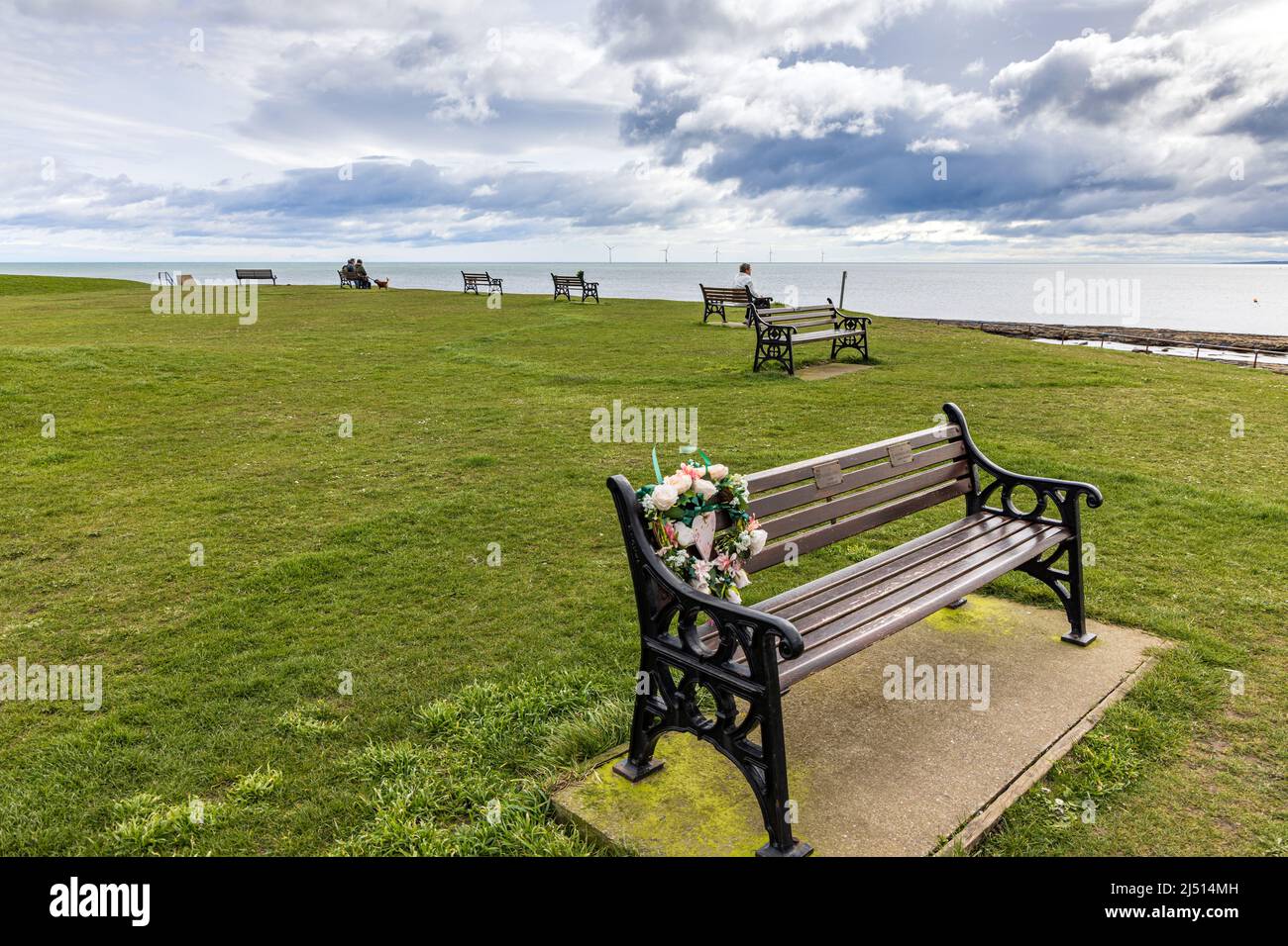 Gedenkbänke am Church Point in der Nähe der St. Bartholomew's Church, Newbiggin-by-the-Sea, Northumberland. Stockfoto