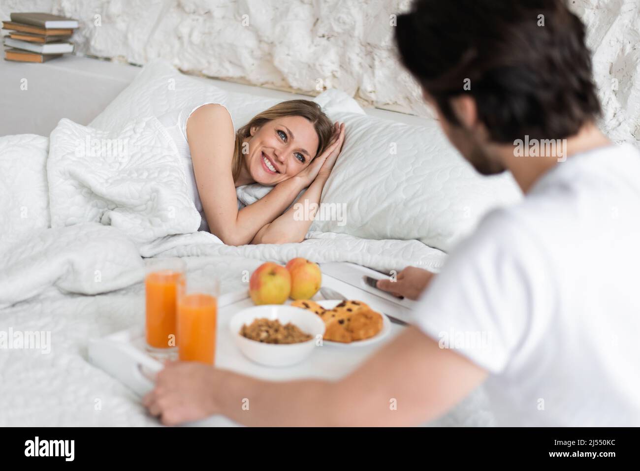 Romantischer junger Mann, der für seine geliebte Frau zu Hause Frühstück  ins Bett bringt Stockfotografie - Alamy