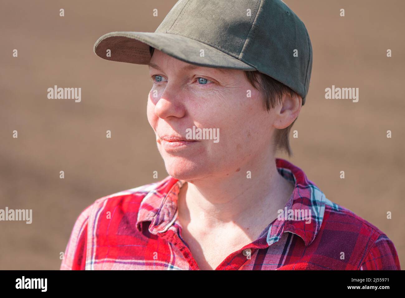 Farmerin mit Baseballmütze und kariertes Hemd, Kopfschuss-Porträt auf dem Feld, selektiver Fokus Stockfoto
