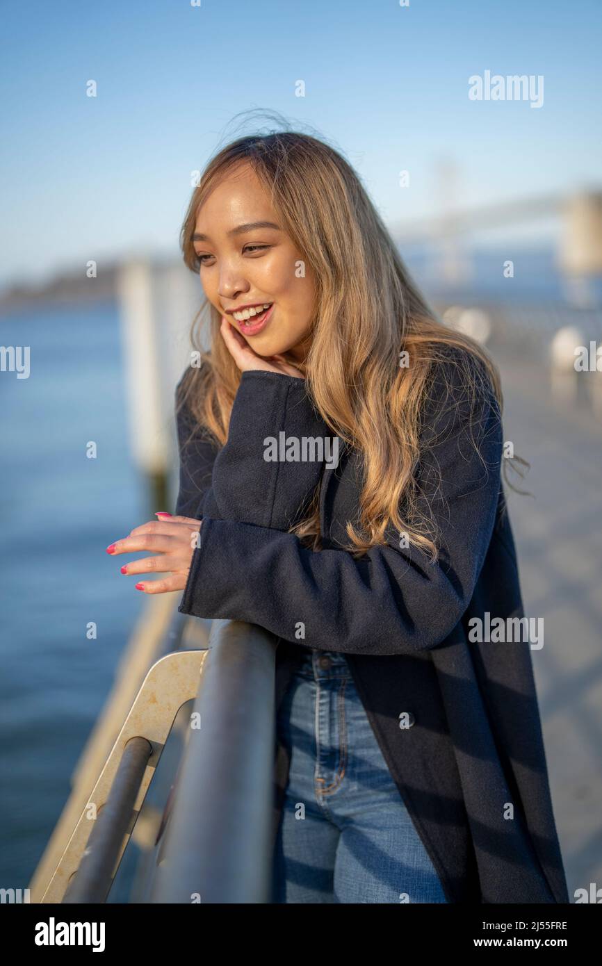 Happy Young Woman Leaning on the Reling of a Pier in San Francisco | Lifestyle Local Tourism Stockfoto