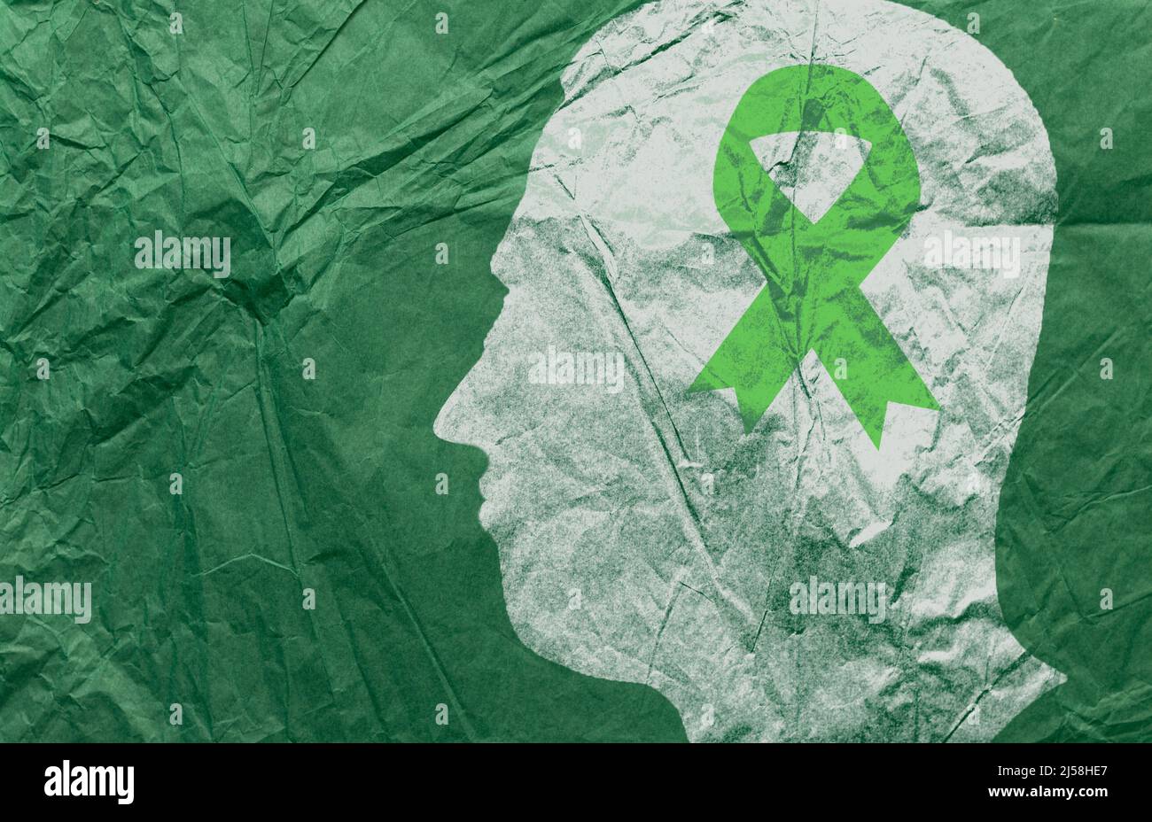 Männliche Kopf Silhouette und grünes Band Papier. Konzept des Monats des Bewusstseins für psychische Gesundheit. Als Symbol der Diognose und Prävention von psychischen Störungen. Stockfoto