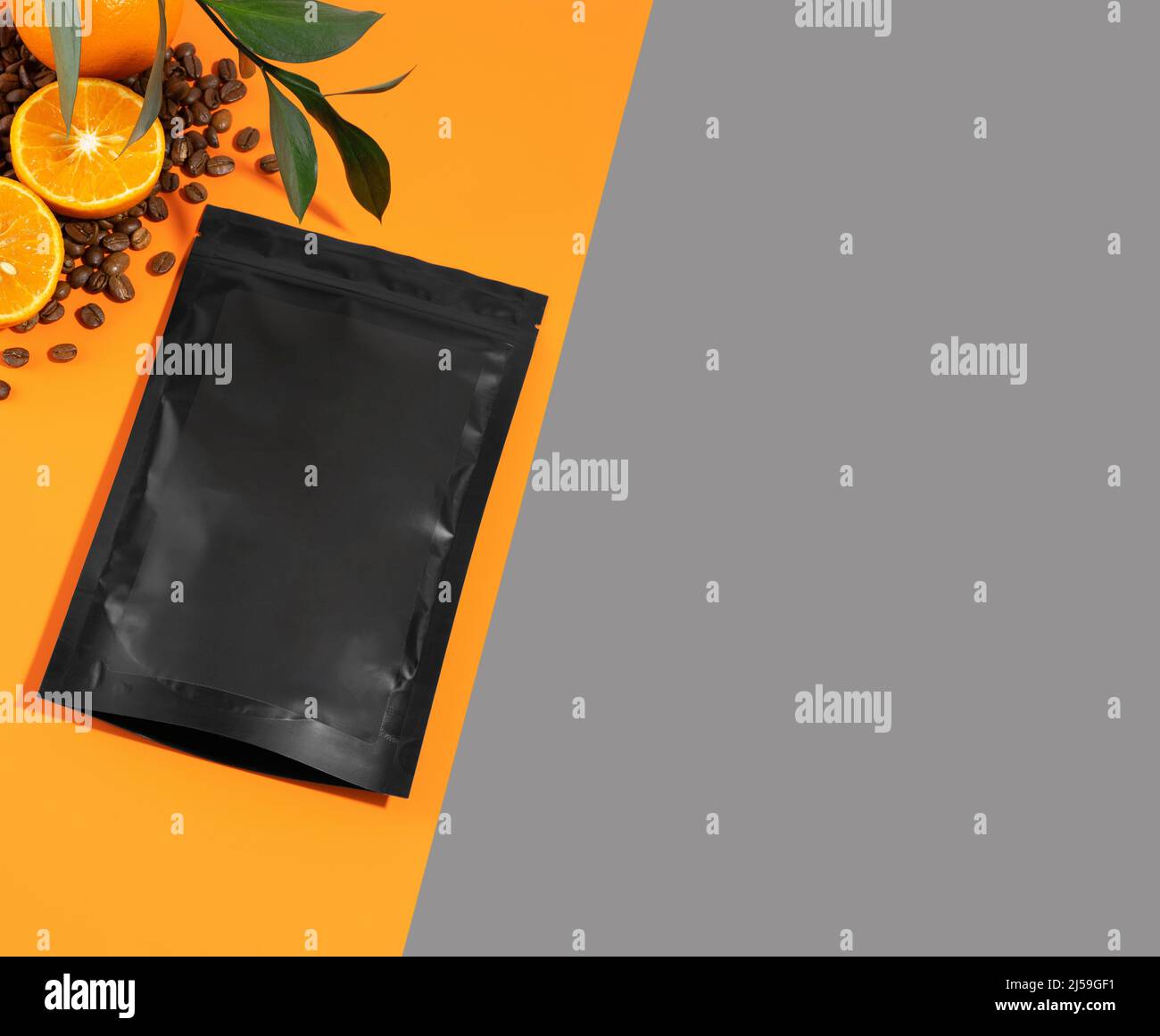 Eine Packung Anti-Cellulite-Peeling auf einem orangen Hintergrund. Körperpeeling mit ätherischen Ölen aus Kalk, Kaffee und Mandarine. Kosmetisches Produkt Stockfoto