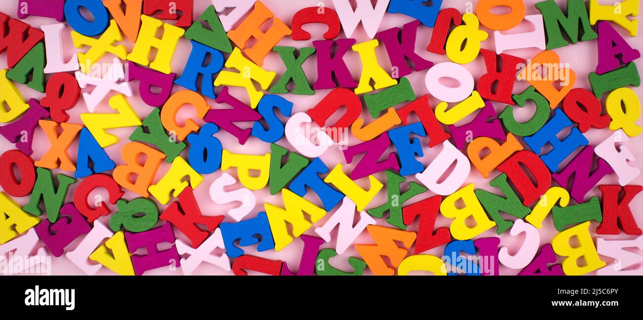 Bunte helle hölzerne Buchstaben auf rosa Banner Hintergrund. Zurück zum Schulkonzept. Stockfoto