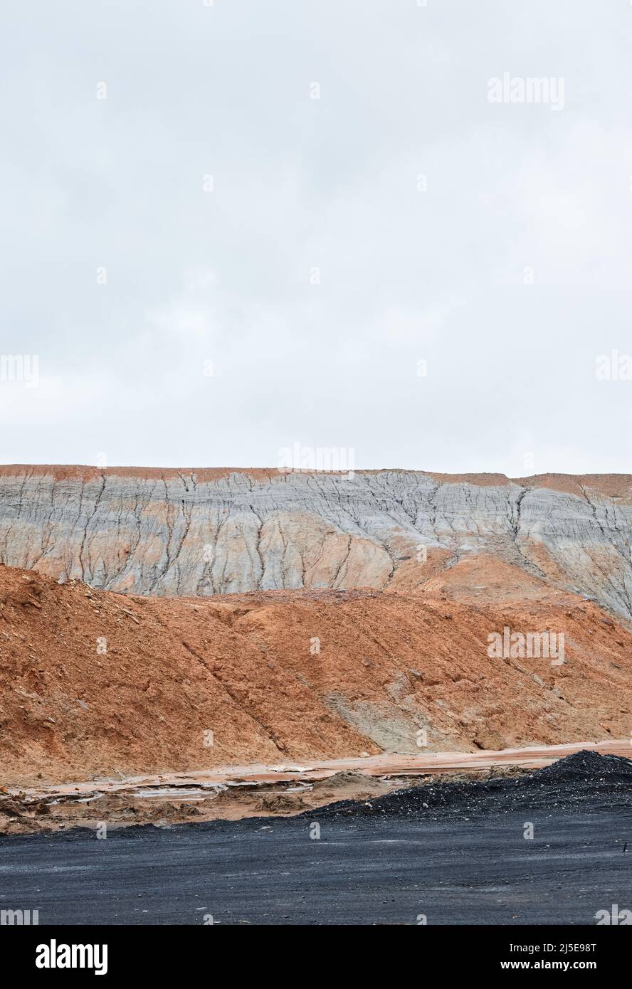 Giftige Abfallland mit verschmutztem Boden von schwarzen und orangefarbenen Farben, ökologisches Katastrophenkonzept Stockfoto