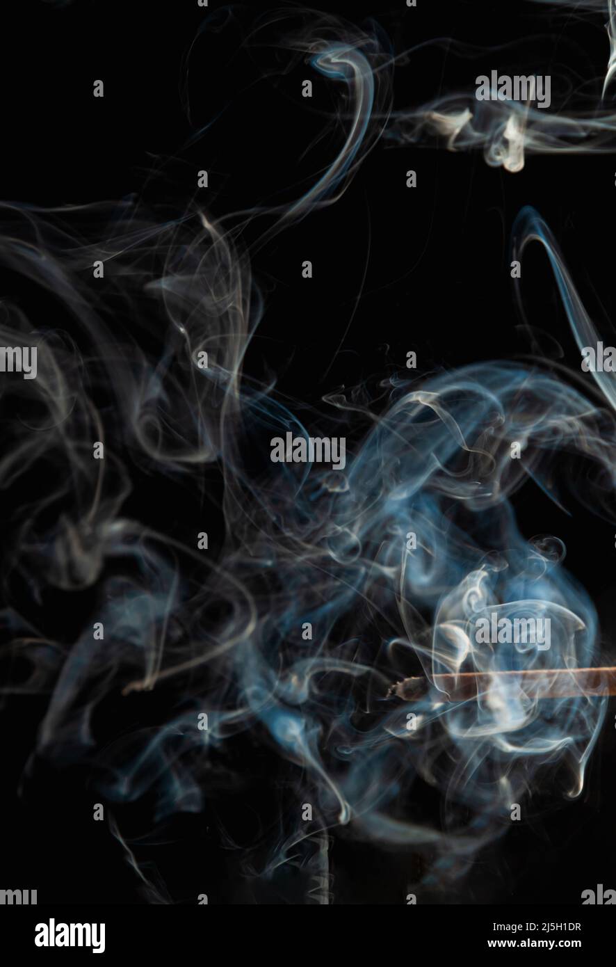Blauer Rauchschwaden auf schwarzem Hintergrund. Stockfoto