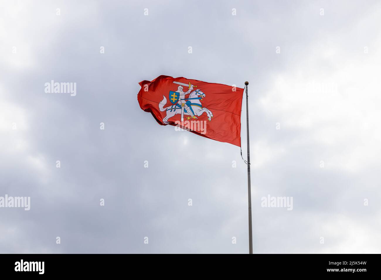 Das Wappen Litauens. Ritter auf einem Pferd auf einem roten Hintergrund im bewölkten Himmel Stockfoto