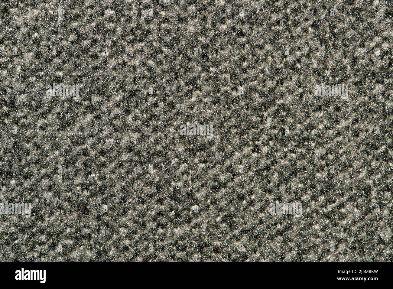 Dunkelgraues Muster der Teppichprobe, Nahaufnahme direkt über dem Vollbildbild. Stockfoto