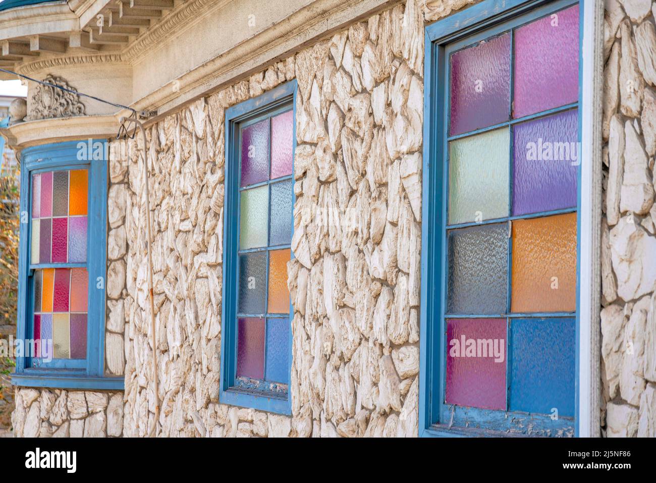Gebäude außen mit grauen gerahmten Fenstern mit bunten Glasscheiben in San Francisco, Kalifornien Stockfoto