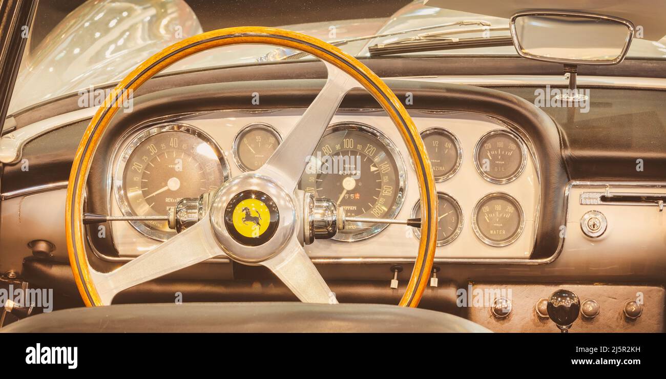 ESSEN, DEUTSCHLAND - 23. MÄRZ 2022: Retro-Style-Iamge des Interieurs eines klassischen Ferrari-Sportwagens mit Holzlenkrad in Essen, Deutschland Stockfoto