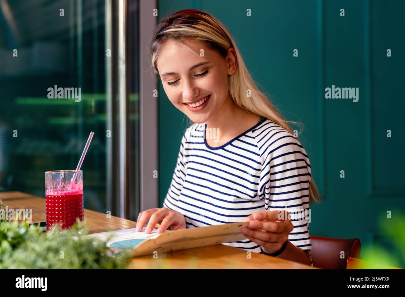 Junge Frau mit einem guten Morgen gesunden Smoothie-Getränk aus Superfoods. Gesundheitskonzept der Menschen Stockfoto