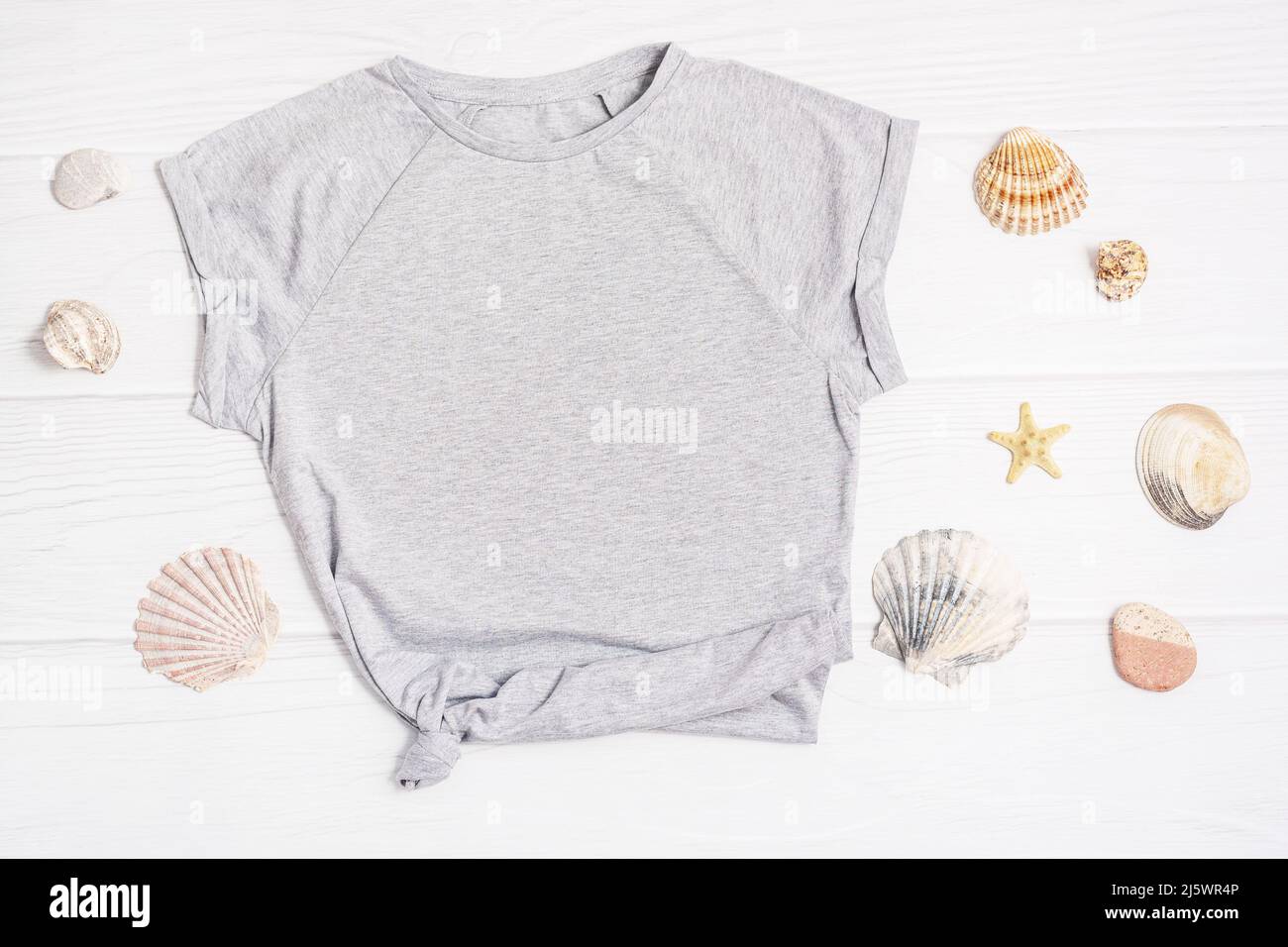 T Shirt mockup flach Lay Muscheln weißen Holzhintergrund. Stockfoto