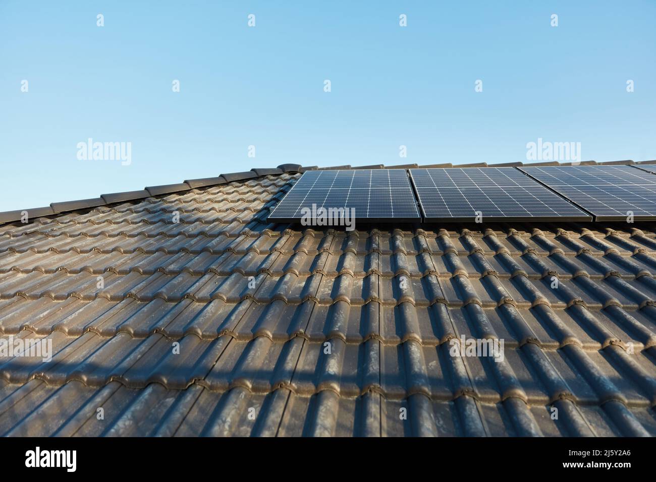 Sonnensystem auf dem Dach des Familienhauses gegen den blauen Himmel Stockfoto