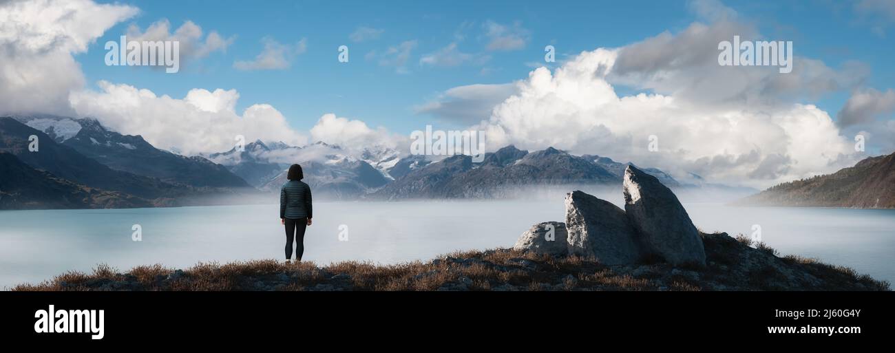 Frau, die an der Rocky Ocean Coast steht. Wolkenverhangener Himmel – Art Rendern. Stockfoto