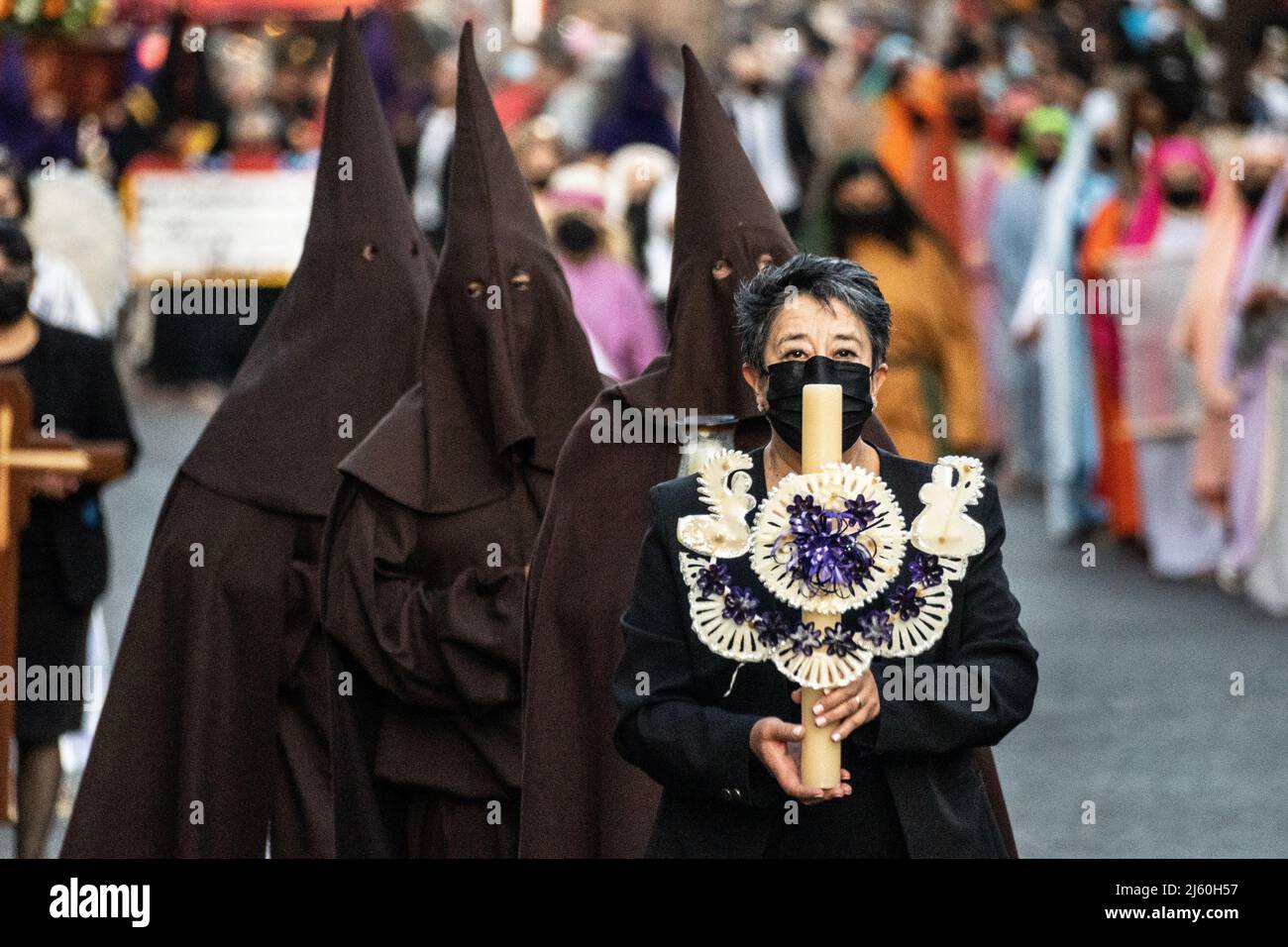 Römisch-katholische Büßer mit Kapuze und traditionellen Capiroten halten am Karsamstag, dem 16. April 2022, in Patzcuaro, Michoacan, Mexiko, eine Prozession des Schweigens ab. Die kleine indigene Stadt bewahrt die Traditionen der spanischen Kolonialherrschaft, einschließlich der Bruderschaft der Büßer während der Karwoche. Stockfoto