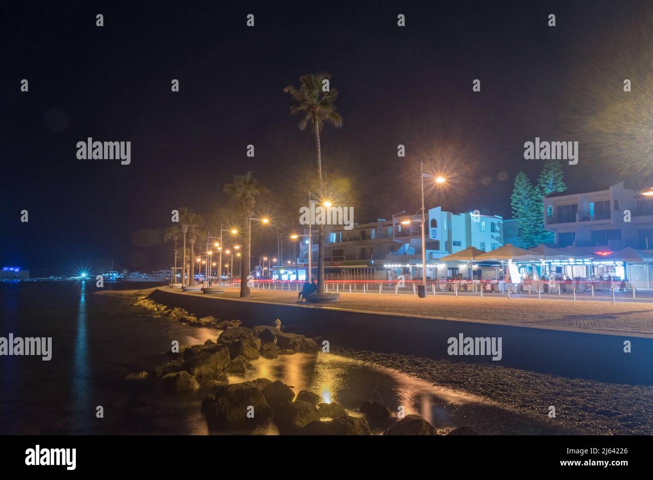 Paphos, Zypern - 2. April 2022: Uferpromenade und Touristenallee am Mittelmeer in der Nacht. Stockfoto