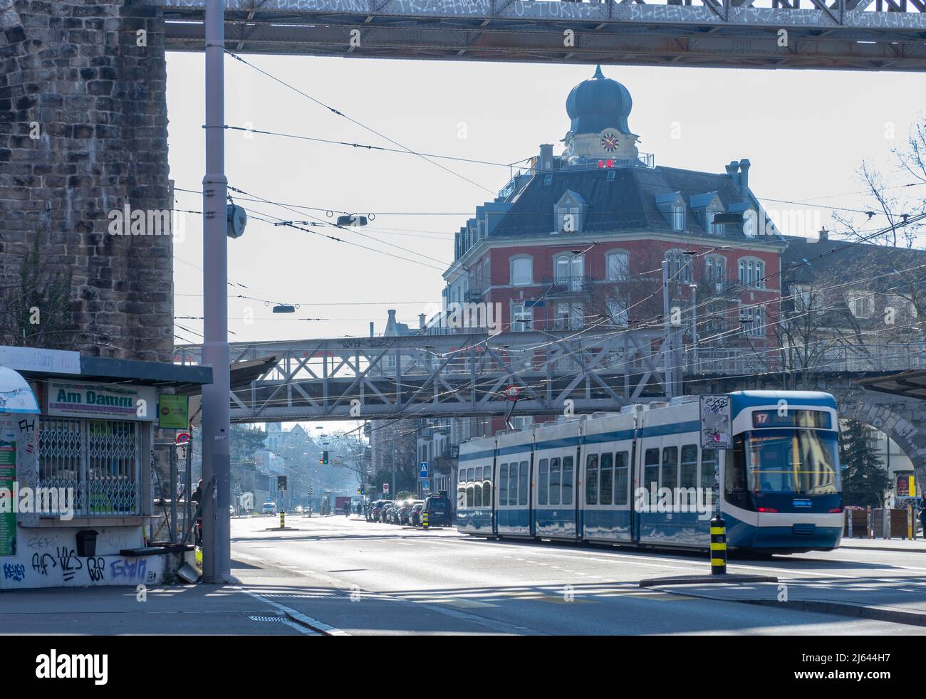 Zürich, Schweiz - März 5. 2022: Eine Trambahn, die unter einer Eisenbahnbrücke in einem Wohngebiet überquert Stockfoto