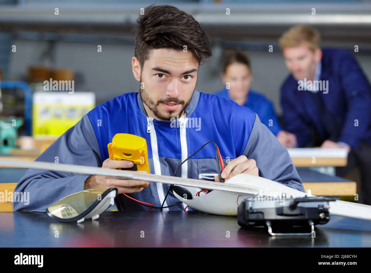 Elektrolehrer, der in einem Klassenzimmer an einem Industrieunterricht arbeitet Stockfoto