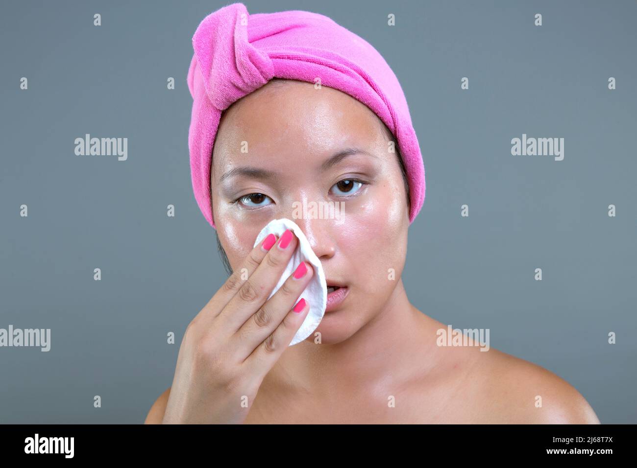 Junge asiatische Ethnie Frau Reinigung ihr Gesicht Stockfoto