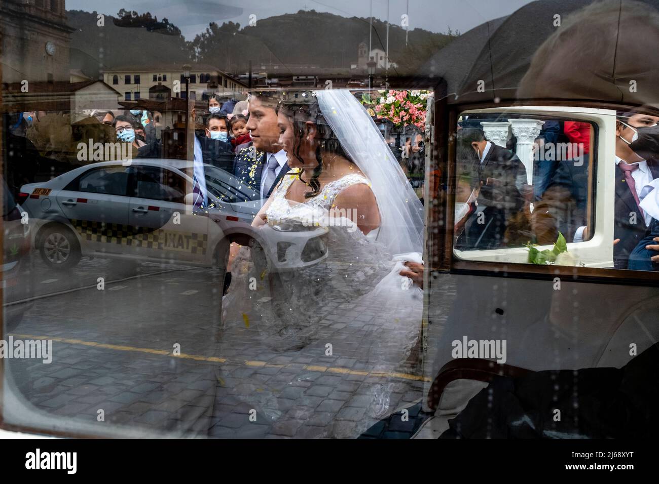Ein junges peruanisches Paar kommt in ihr Hochzeitsauto, nachdem es in der Kathedrale, Plaza De Armas., Cusco, Provinz Cusco, Peru geheiratet hat. Stockfoto