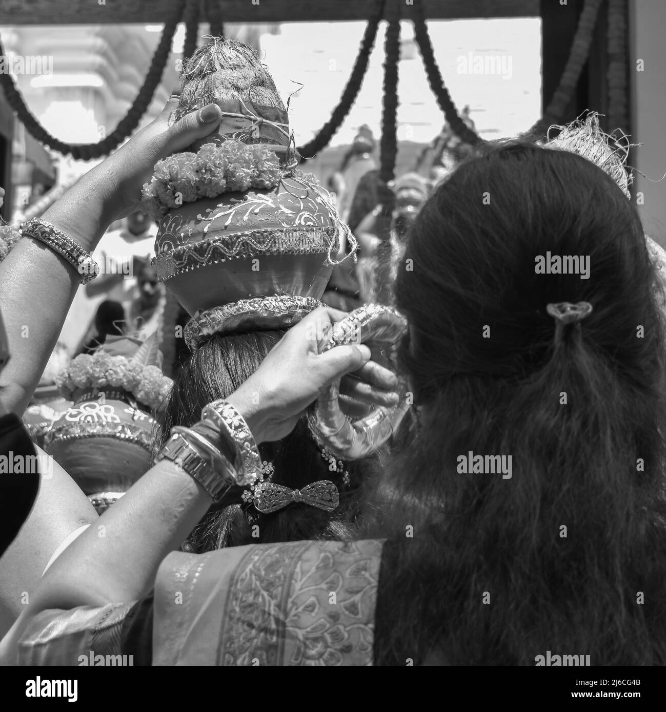 Frauen mit Kalash am Kopf während des Jagannath-Tempels Mangal Kalash Yatra tragen indische Hindu-Anhänger irdische Töpfe mit heiligem Wasser und Kokosnuss o Stockfoto