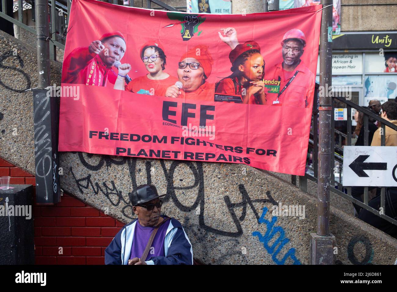 Während einer internationalistischen Friedensmesse in Brixton wird ein Banner der wirtschaftlichen Freiheitskämpfer gesehen, während die Menschen den Rednern zuhören. Die Economic Freedom Fighters (EFF) ist eine südafrikanische radikale und militante wirtschaftliche Emanzipationsbewegung unter der Führung von Julius Malema. Stockfoto