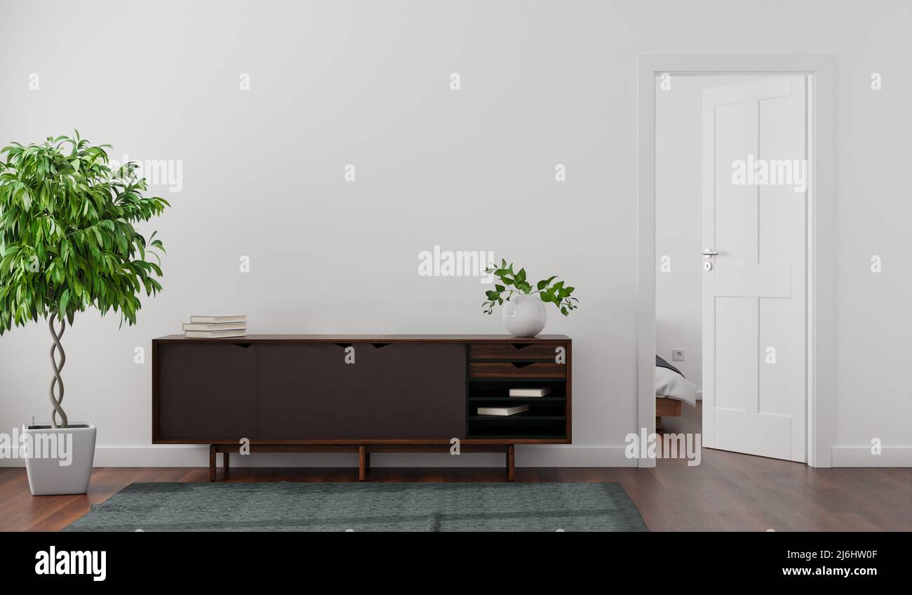 Apartment-Mockup mit einer weißen Wand, Sideboard, Porzellanvase, Büchern, Feigenbaum und einem Teppich. Tür zum Schlafzimmer offen. Bett teilweise sichtbar. Stockfoto