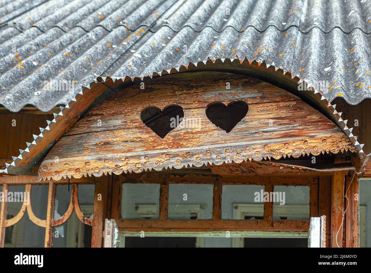 Außenansicht des alten Hauses im Dachgeschoss. Geschnitzte Herzen in das Holz Stockfoto