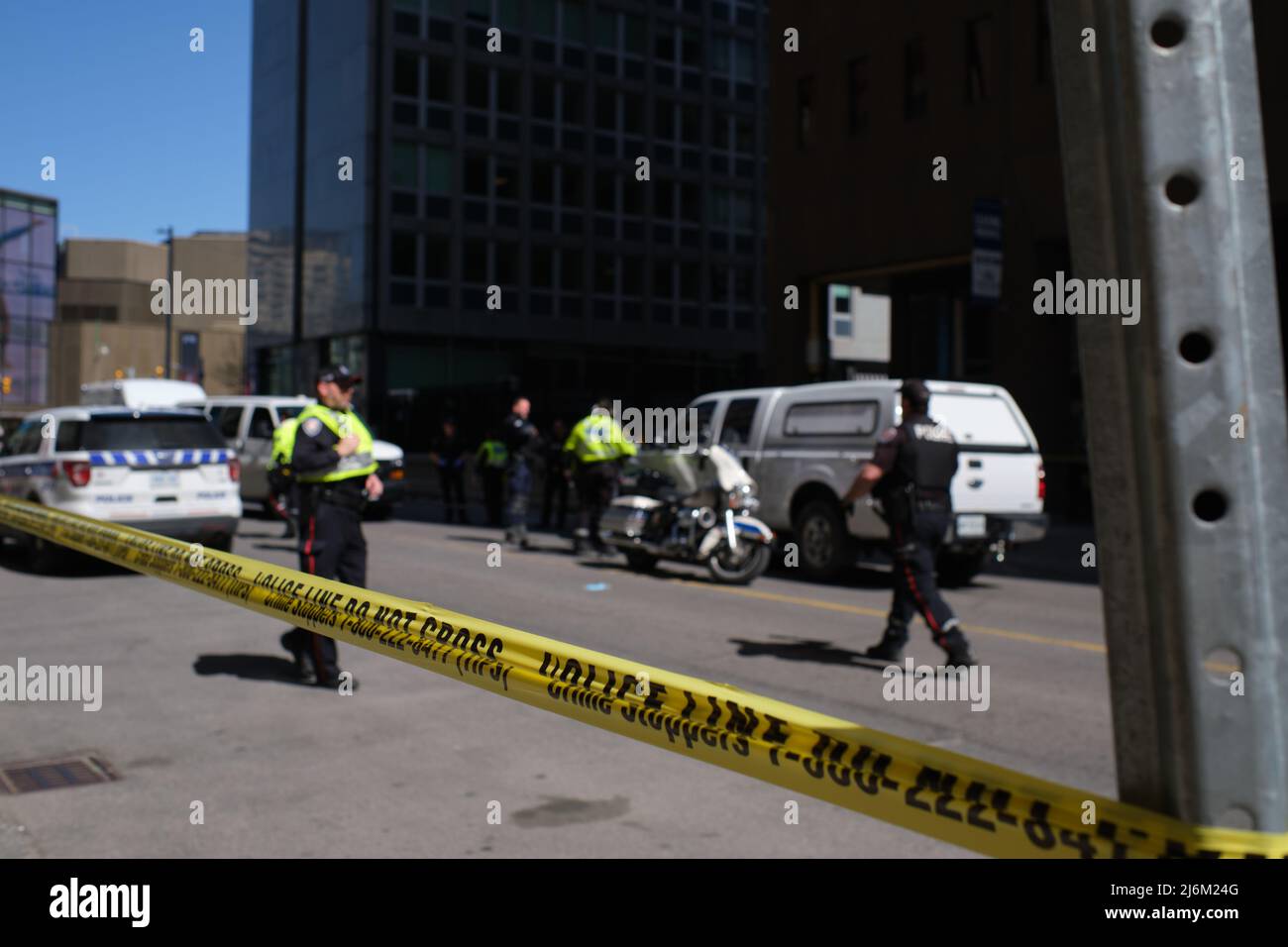 Ottawa, Ontario, Kanada - 30. April 2022: Gelbes Polizeiband umschließt einen Abschnitt der Innenstadt von Queen Street, während Beamte des Polizeidienstes von Ottawa Ermittlungen aufstellten Stockfoto