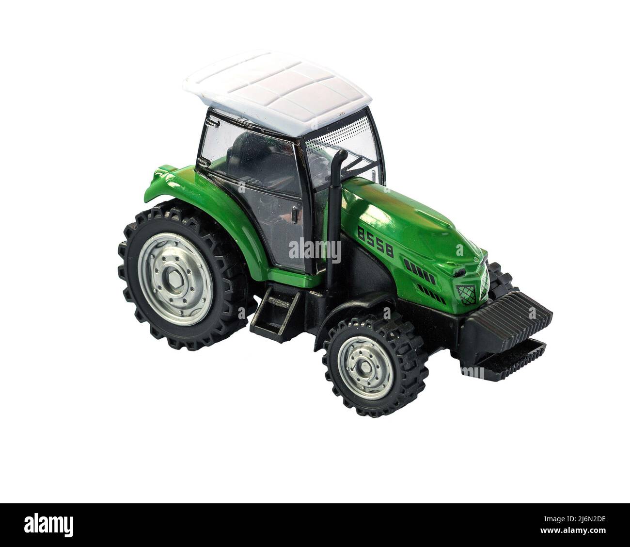 Grünes Traktor Spielzeug isoliert auf weißem Hintergrund Stockfoto