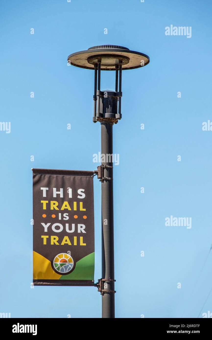 4-2-2022 Tulsa OK USA - This Trail is your Trail - Sign along Riverwalk echoes Guthris Song This Land is your Land - mounted on retro light Pole again Stockfoto