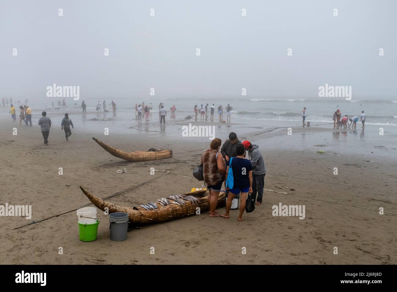 Einheimische Verkaufen Frischen Fisch Von Ihren Caballitos De Totora (Traditionelle Schilfboote), Pimentel Beach, Chiclayo, Provinz Chiclayo, Peru. Stockfoto