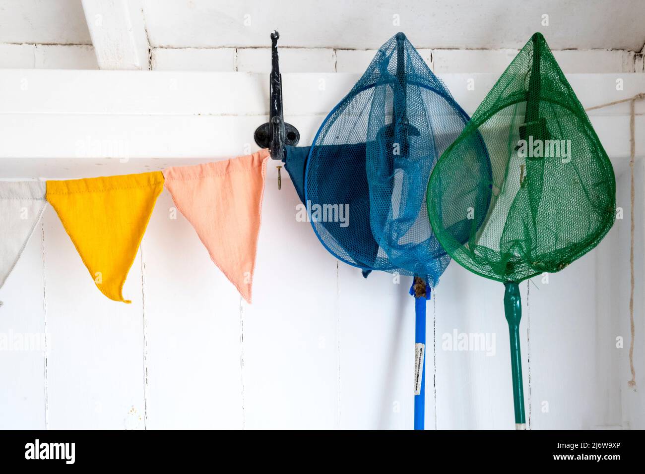 Bunte Kinder-Garnelennetze hingen in einer Strandhütte in Wells-next-the-Sea an der Nord-Norfolk-Küste auf. Stockfoto