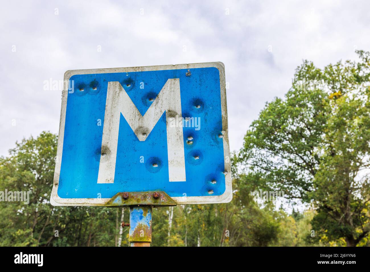 Einschusslöcher in einem Straßenschild für einen Treffpunkt Stockfoto