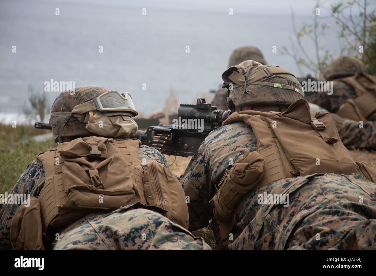 U.S. Marine Corps Lance CPL. Reh Kay, links, und Lance CPL. Andrew Tracy, Schüler des Advanced Infantry Marine Course mit Advanced Infantry Training Bataillon, School of Infantry-West, Hawaii Detachment, offenes Feuer auf fiktive feindliche Ziele während einer Trainingsübung, Ulupa’U Crater, Marine Corps Base Hawaii, 27. April 2022. AIMC ist eine Fortbildung, die darauf ausgelegt ist, die Fähigkeiten und Führungsfähigkeiten der Marine als Truppenführer in einem Gewehrzug zu verbessern und zu testen. (USA Marine Corps Foto von Lance CPL. Terry Stennet III) Stockfoto