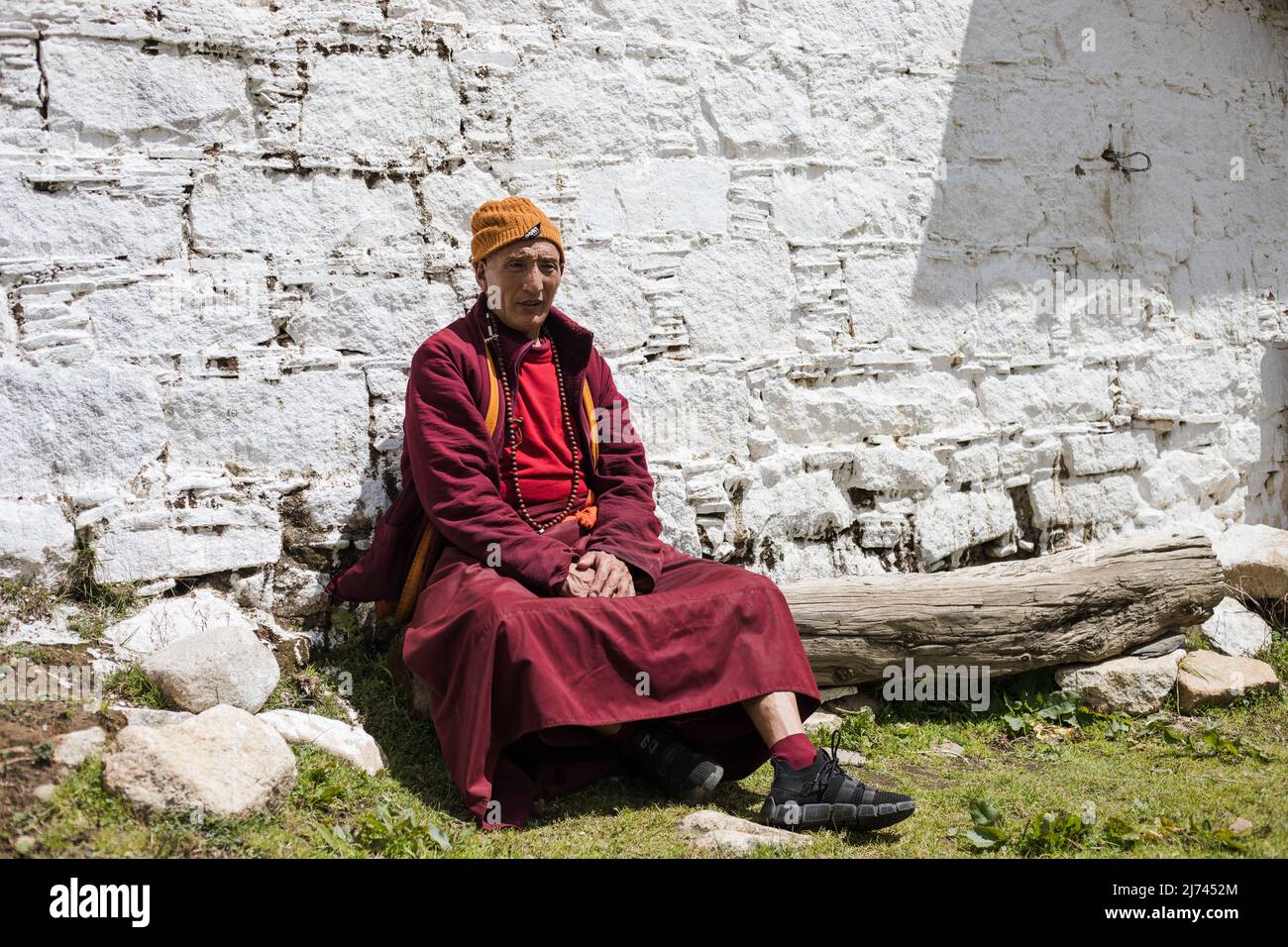 Porträt eines buddhistischen Mönchs, der auf einer Bank in Sichuan ruht Stockfoto