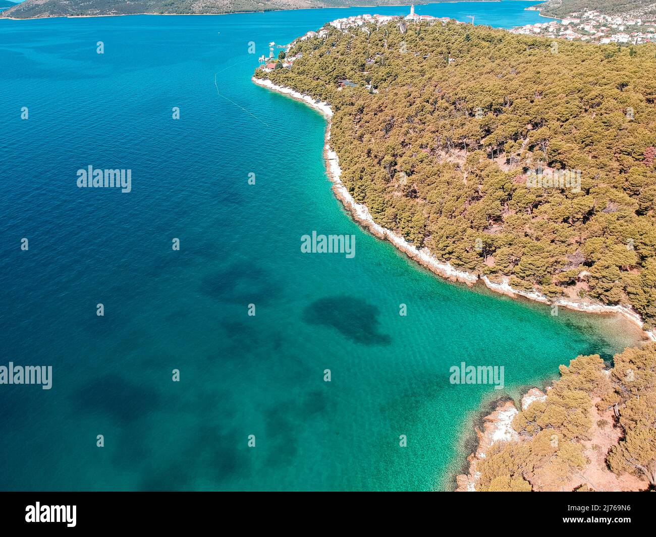 Von oben können Sie das Meer und einen Teil des Gebiets von Seget Vranjica in Kroatien sehen. Im Vordergrund viel Wald. Stockfoto