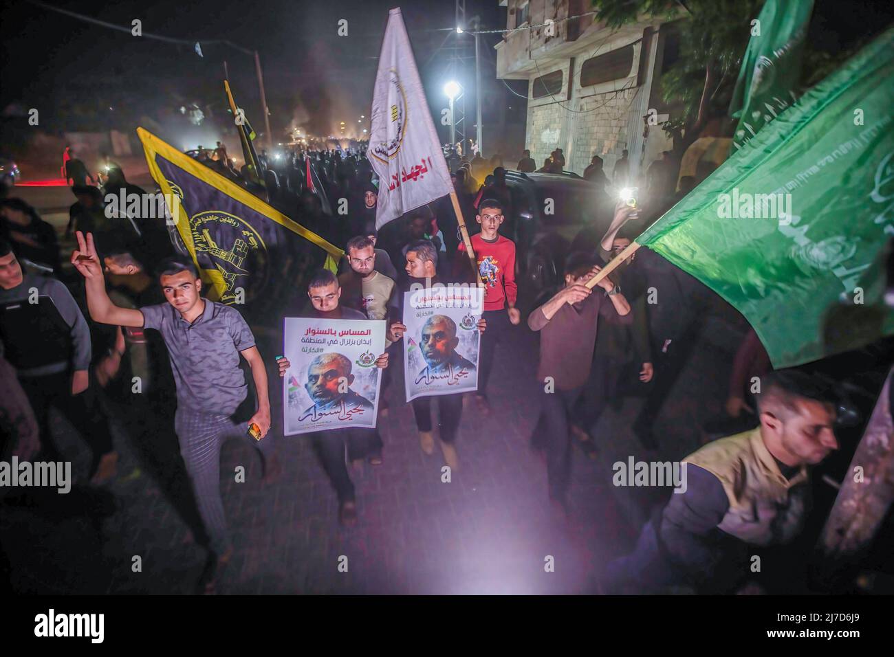 Palästinensische Hamas-Anhänger zeigen Bilder des Hamas-Führers Yahya Sinwar, während sie in Richtung seines Hauses marschieren, um der Widerstandsführung und als Reaktion auf die israelischen Drohungen ihre Treue zu versprechen. Die israelische Armee übermittelte der Hamas in Gaza eine Botschaft, dass sie die Entscheidung zur Liquidation von Yahya Sinwar getroffen hatte. (Foto von Yousef Masoud / SOPA Images/Sipa USA) Stockfoto