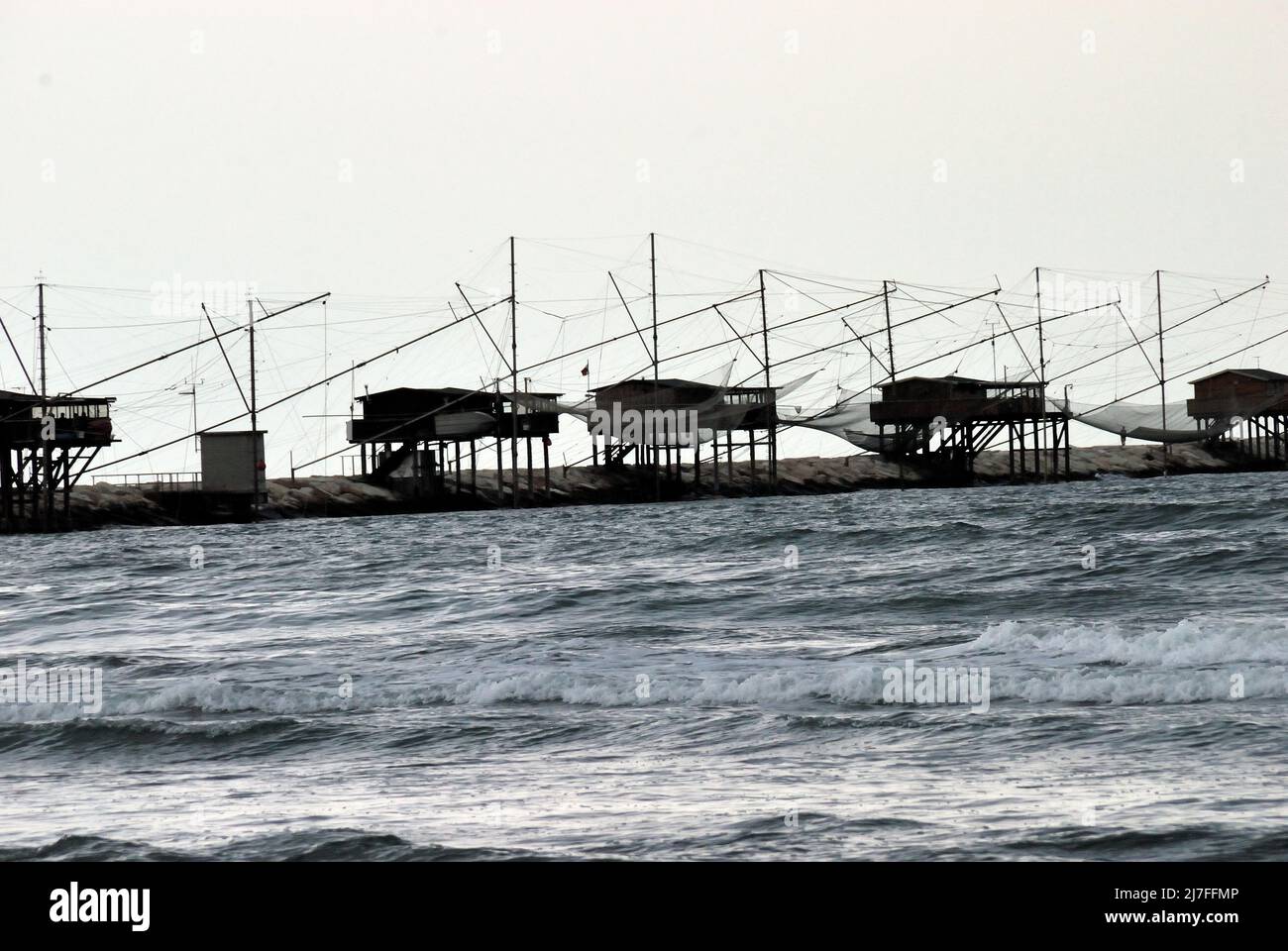 Adriaküste von Venetien, Strand Sottomarina. Alte Fischmaschinen. Schlechtes Wetter, Wind- und Seesturm trafen die Küste. Stockfoto