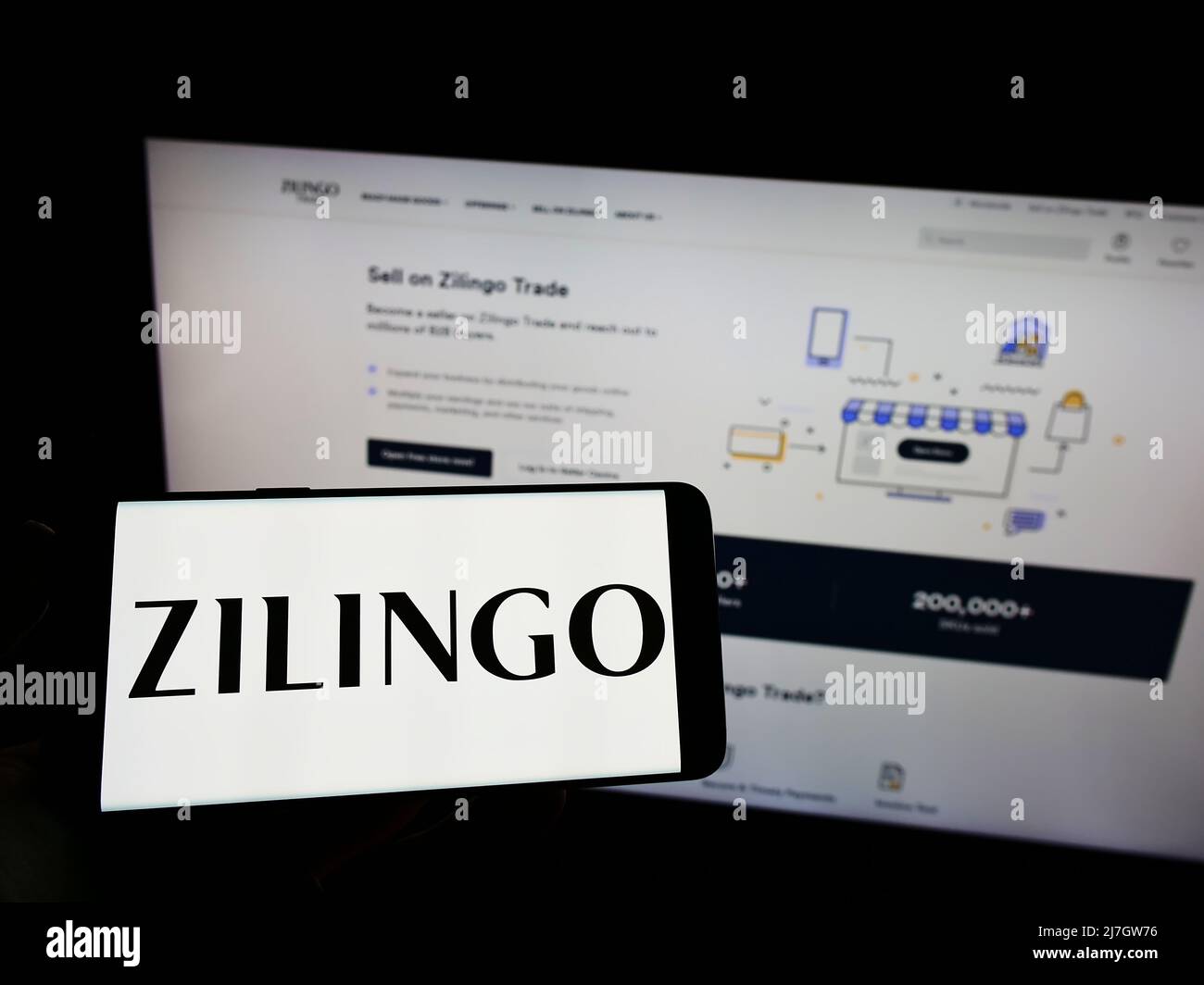 Person, die Mobiltelefon mit dem Logo des singapurischen E-Commerce-Unternehmens Zilingo Pte. Ltd. Auf dem Bildschirm vor der Webseite hält. Konzentrieren Sie sich auf die Telefonanzeige. Stockfoto