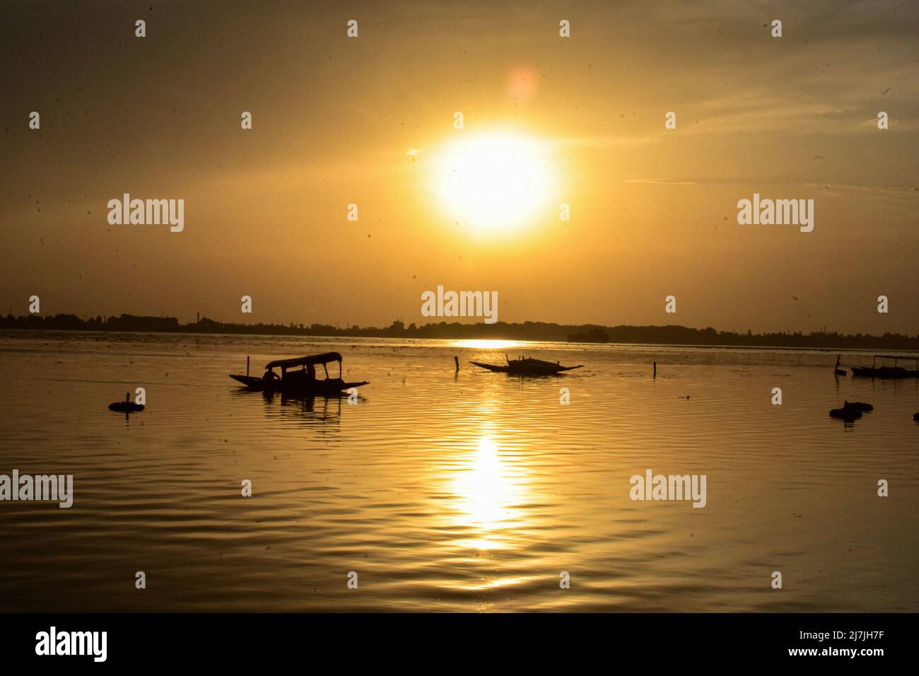 Srinagar, Indien. 09.. Mai 2022. Ein Mann rudert sein Boot über Dal See während eines Sonnenuntergangs in Srinagar. Am Donnerstag wurden vier Menschen getötet und eine Frau verletzt, als Wolkenbruch und böige Winde in Teilen des Kaschmir-Tals verheerende Schäden anrichteten. Der Wettermann prognostizierte einen Temperaturanstieg für die nächsten 2 Tage, Regen ab Mai 12. Kredit: SOPA Images Limited/Alamy Live Nachrichten Stockfoto