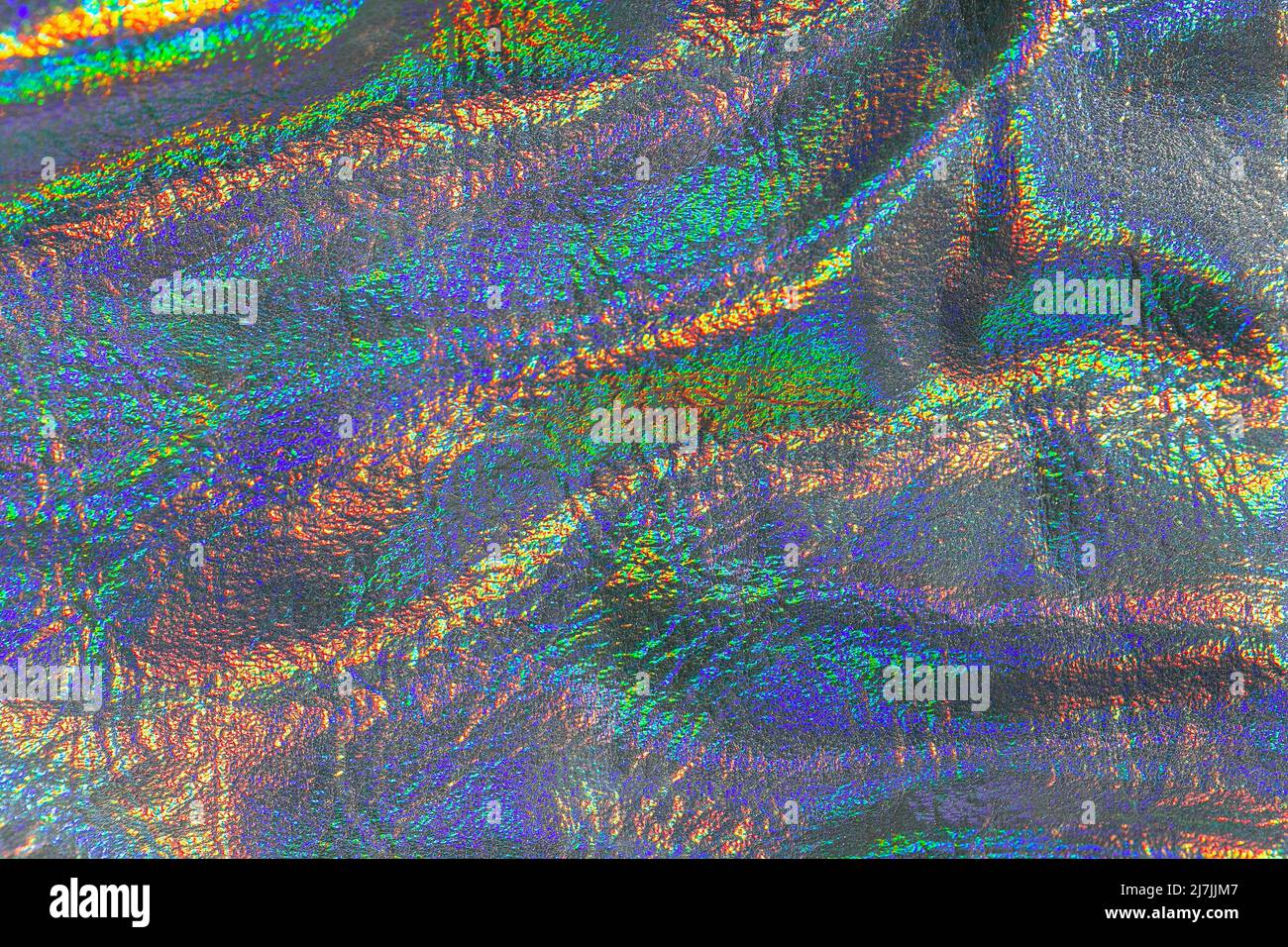 Holographisches Material.Textur mit schillernden Wellen. Tapete in Silber, lila Farben. Stockfoto
