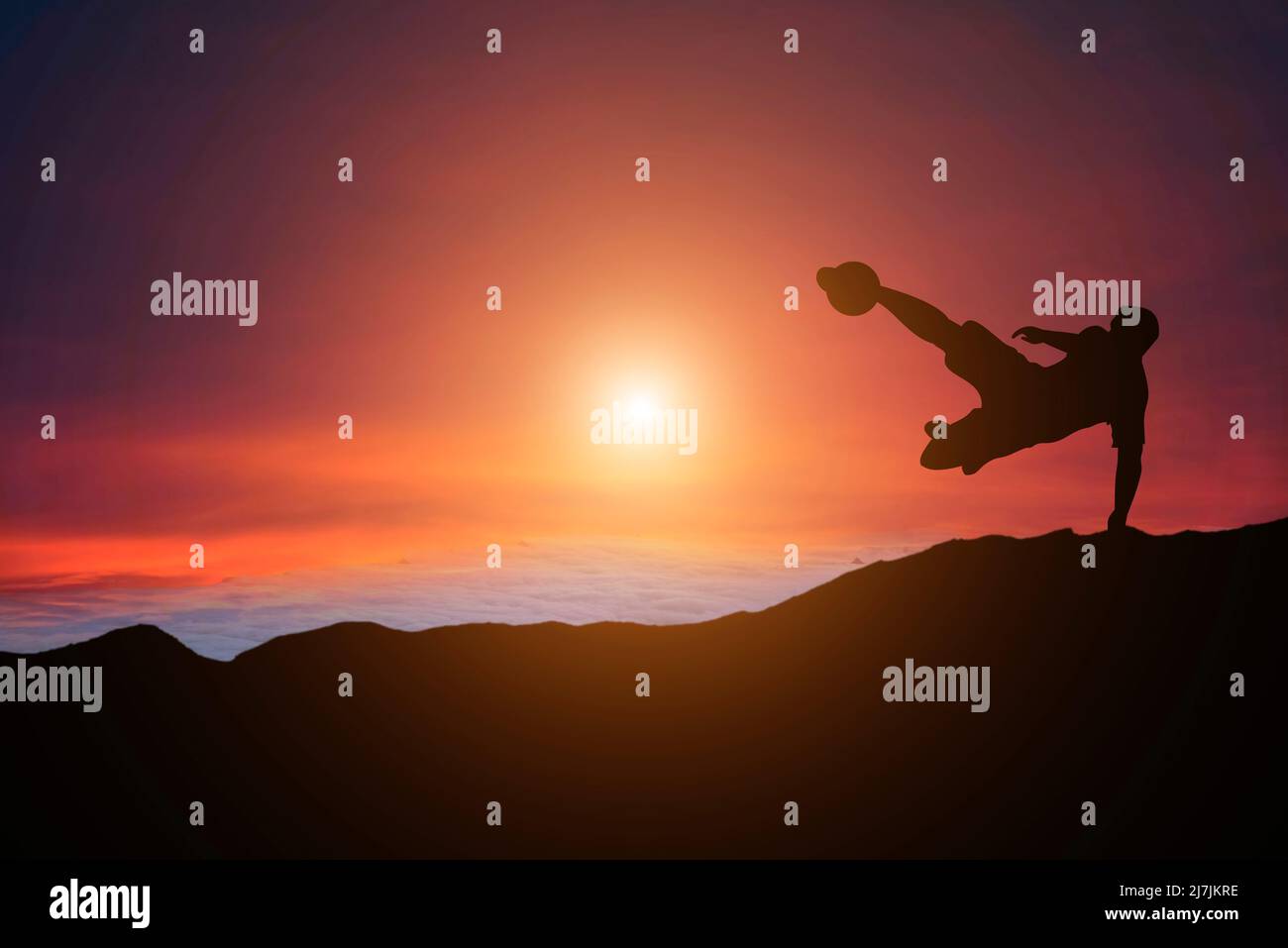 Silhouette eines Fußballspielers bei Sonnenuntergang in der goldenen Stunde Stockfoto