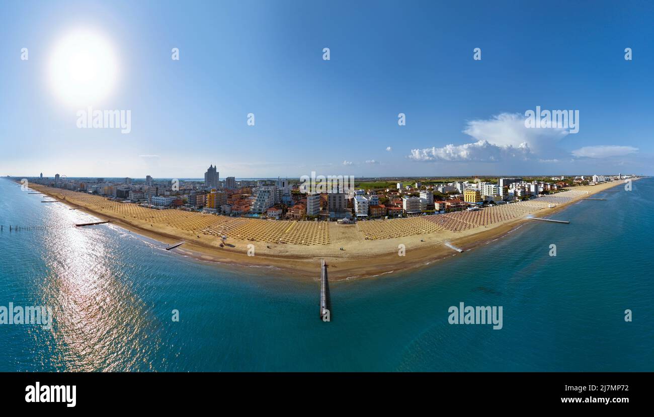 Jesolo in einem Luftpanorama von oben auf blauem Meer und Himmel - goldener Strand und Stadtpaläste an sonnigen Tagen Stockfoto